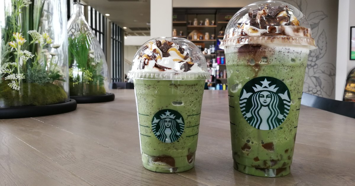 Clientă comandând cafea la o cafenea, privind meniul