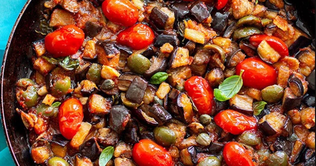 Caponata Siciliană servită într-un castron, cu legume colorate și busuioc