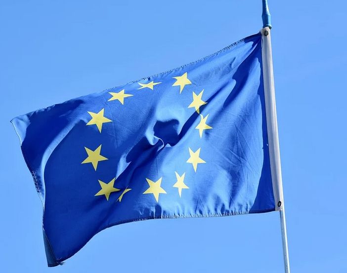 Steagul Uniunii Europene fluturând lângă clădiri moderne