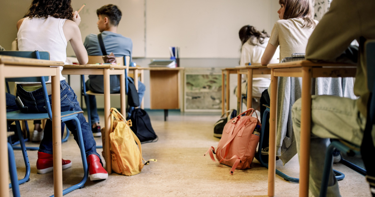 Elevi într-o sală de clasă, lucrând la un proiect cu inteligență artificială