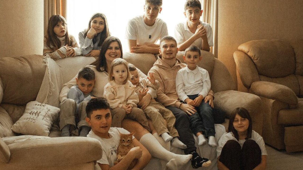 Familia Vidiuk cu cei 10 copii în fața casei din Lvov, Ucraina