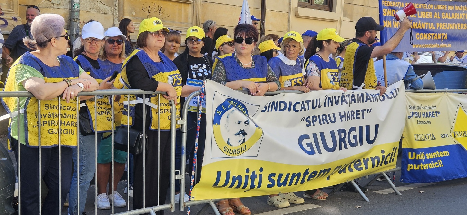 Profesori protestând în fața Guvernului cu bannere
