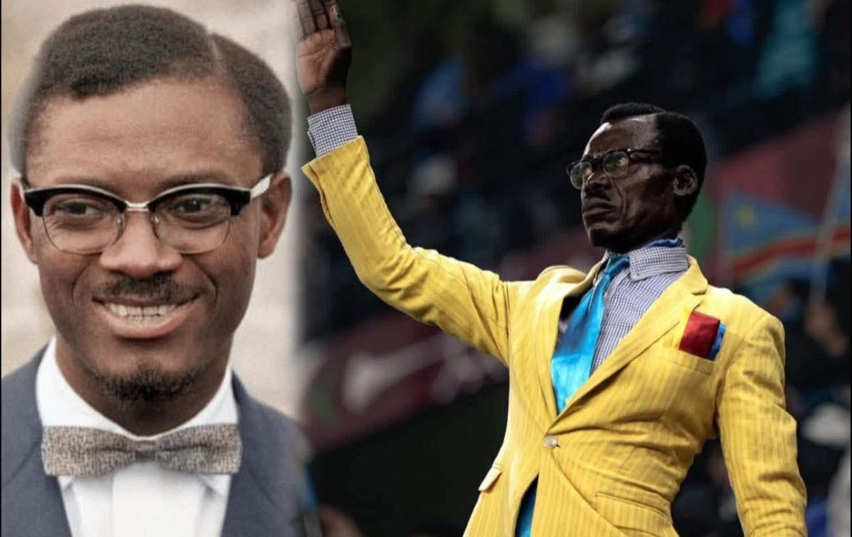 Michel Kuka Mboladinga, suporter al naționalei RD Congo, stând nemișcat cu brațul drept ridicat